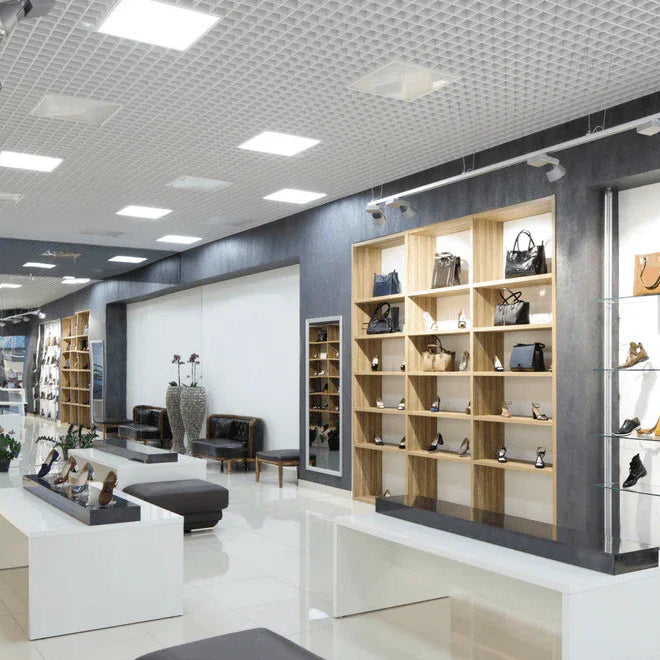 Modern retail store with handbags and shoes, bright lighting, and organized displays